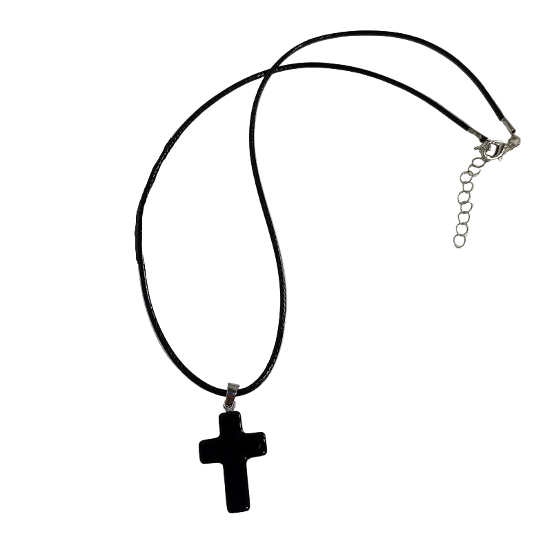 Black cross pendant necklace on a white background