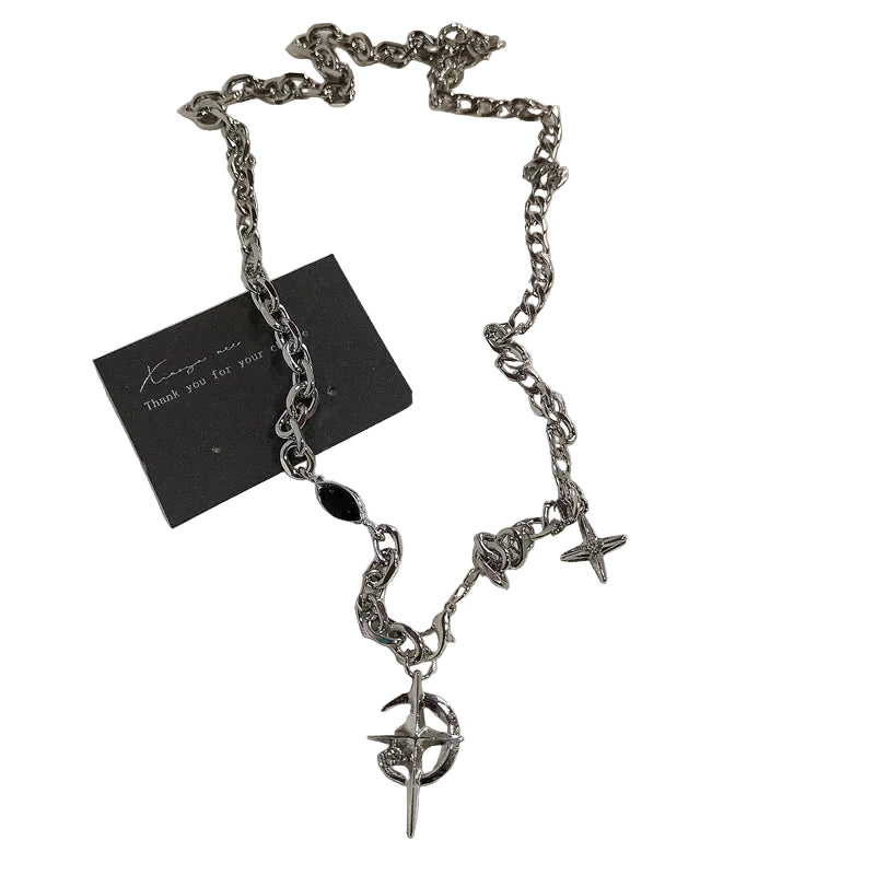 Silver chain necklace with star and circular pendant on a white background